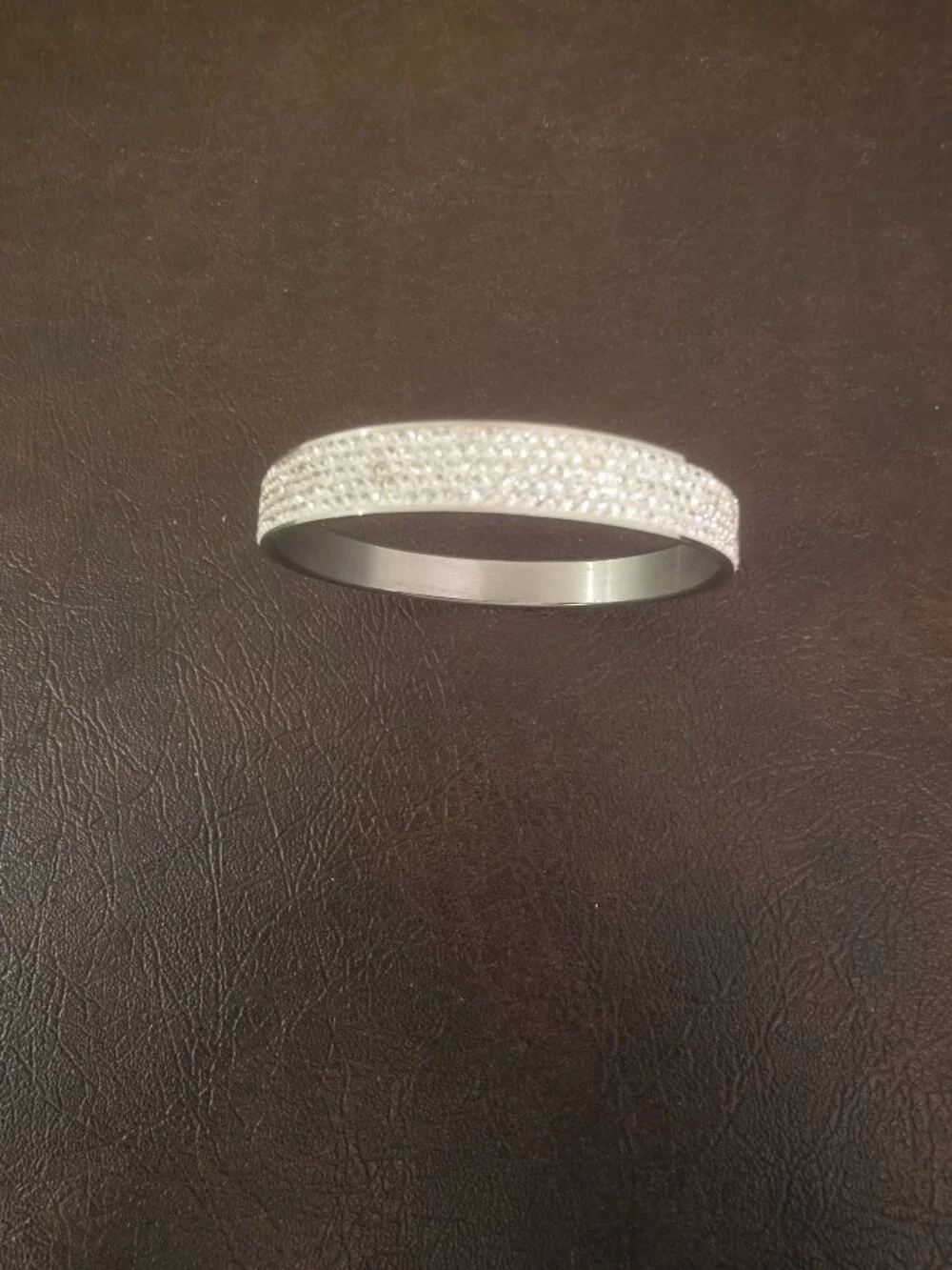 Bracelet bangle features round white/colorless crystal stones